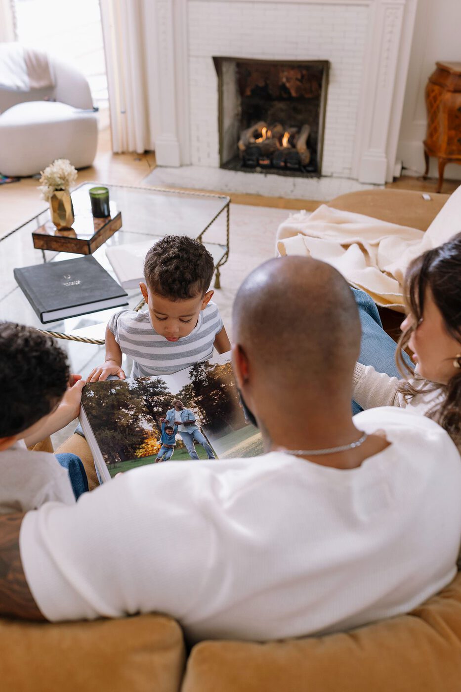 A family looking through their photo album together at home